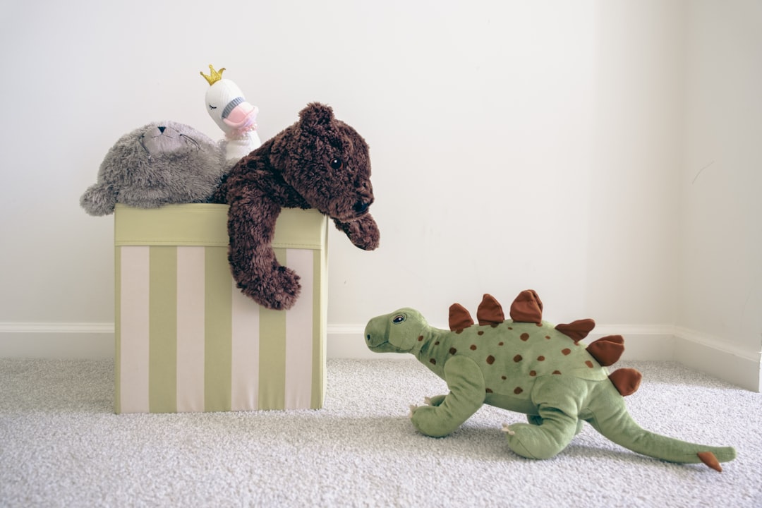 two-stuffed-animals-sitting-on-top-of-a-box-cmblyg7dcdw